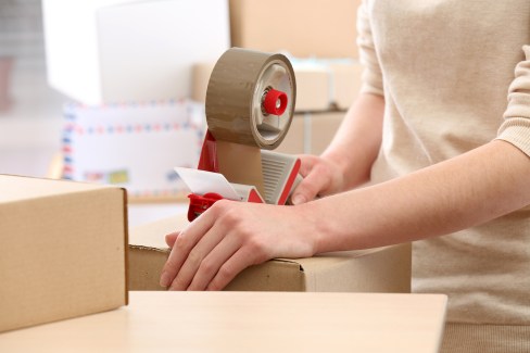 Woman packs parcel in post office